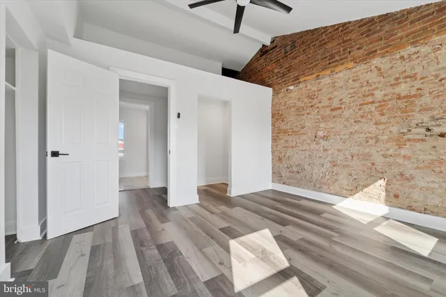a view of an empty room and wooden floor