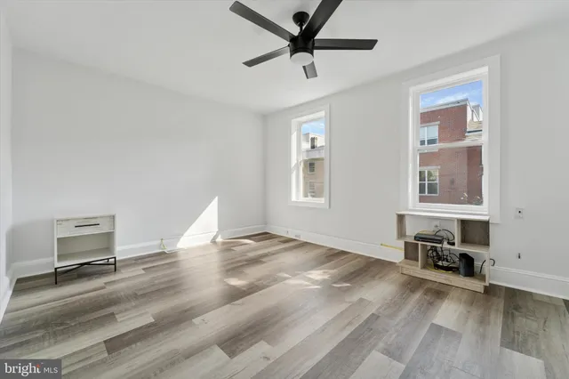 a workspace with wooden floor and windows
