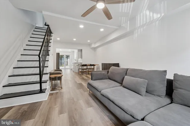 a living room with furniture and wooden floor