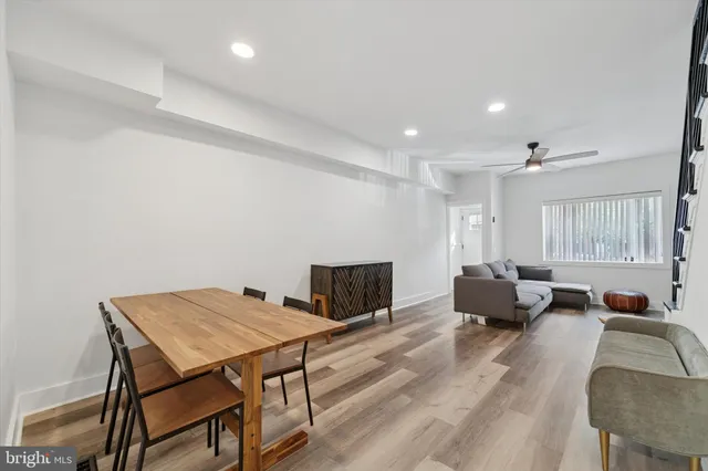 a living room with furniture a table and a large window