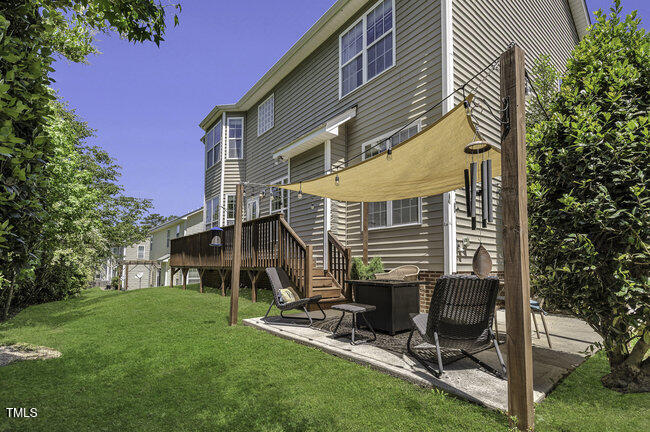 133 Pasadena Road Garner, NC 27529 - Photo 33 of 39 a view of backyard with a chair and table