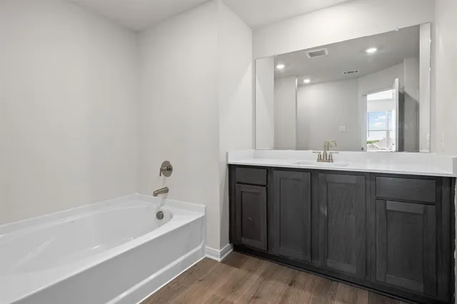 a bathroom with a bathtub and a sink