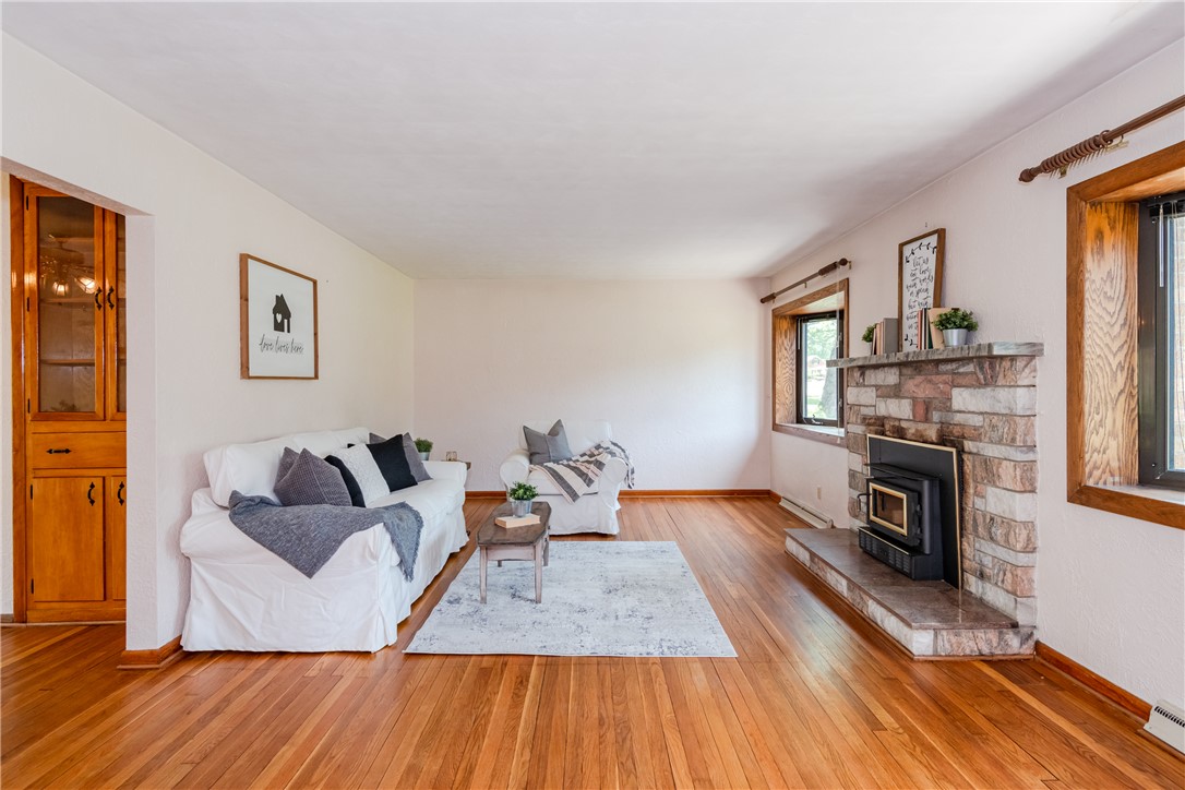 1176 Geneva Road Dayton, OH 45434 - Photo 6 of 55 This inviting living room boasts warm hardwood floors and a striking stone fireplace.