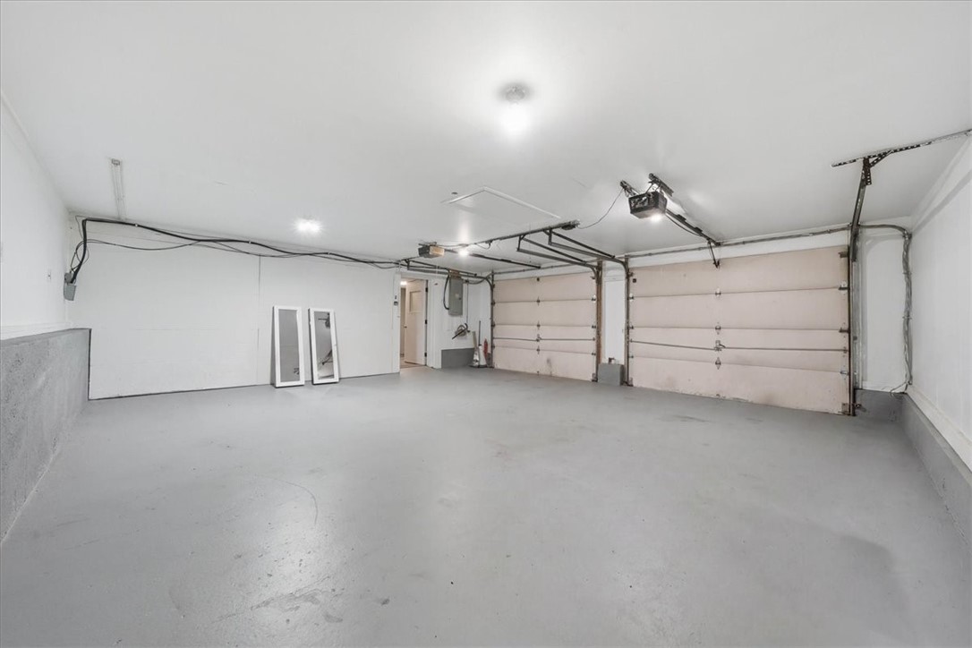 214 Anan Wade Road Glocester, RI 02857 - Photo 32 of 50 Giant 530-sf attached two-car garage is exceptionally spacious, clean, and bright, offering plenty of room for vehicles along with additional storage, tools, bikes, lawn equipment, or hobby space.