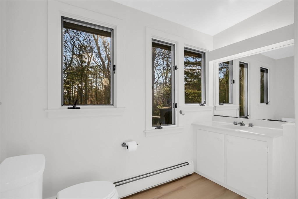 70 Middle Street Lexington, MA 02421 - Photo 25 of 37 a bathroom with a toilet sink and mirror
