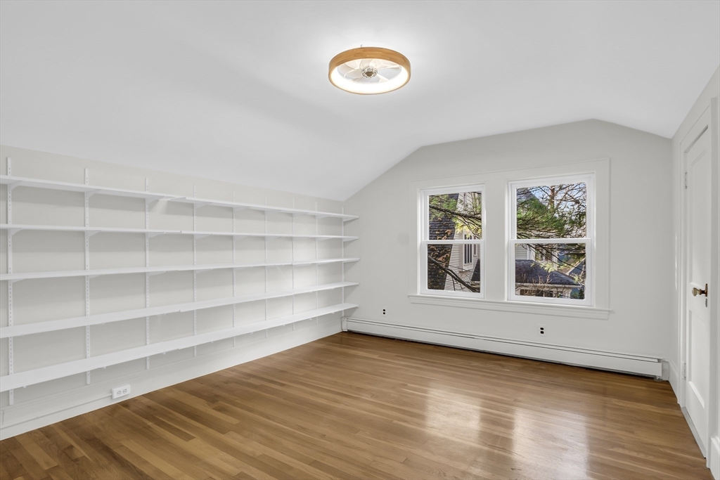 70 Middle Street Lexington, MA 02421 - Photo 27 of 37 a view of an empty room with a window and wooden floor