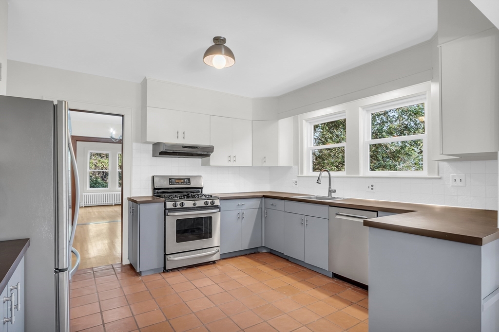 70 Middle Street Lexington, MA 02421 - Photo 10 of 37 a kitchen with a sink cabinets appliances and a window