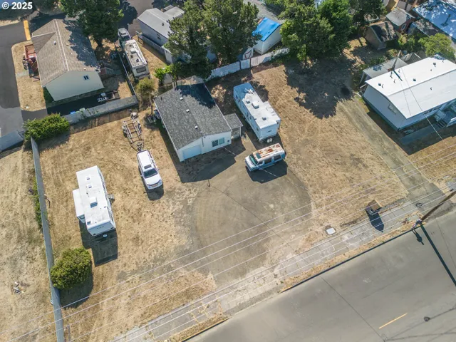 an aerial view of a house with a yard