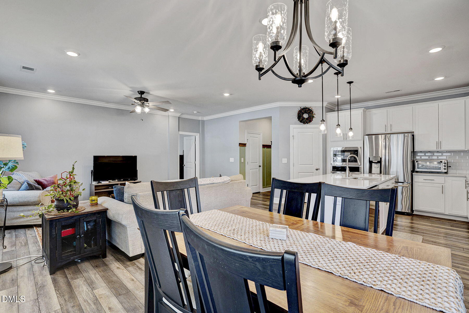 244 Chateau Way Angier, NC 27501 - Photo 13 of 30 a living room with kitchen island furniture and a flat screen tv