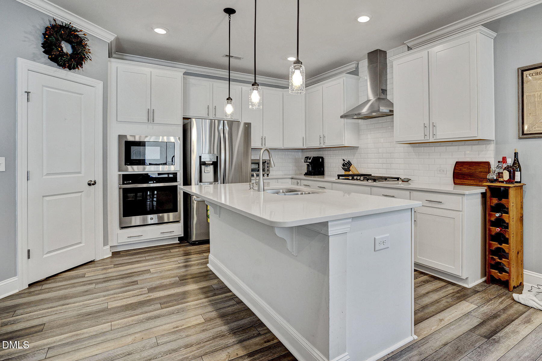 244 Chateau Way Angier, NC 27501 - Photo 14 of 30 a kitchen with stainless steel appliances a stove top oven a refrigerator and cabinets