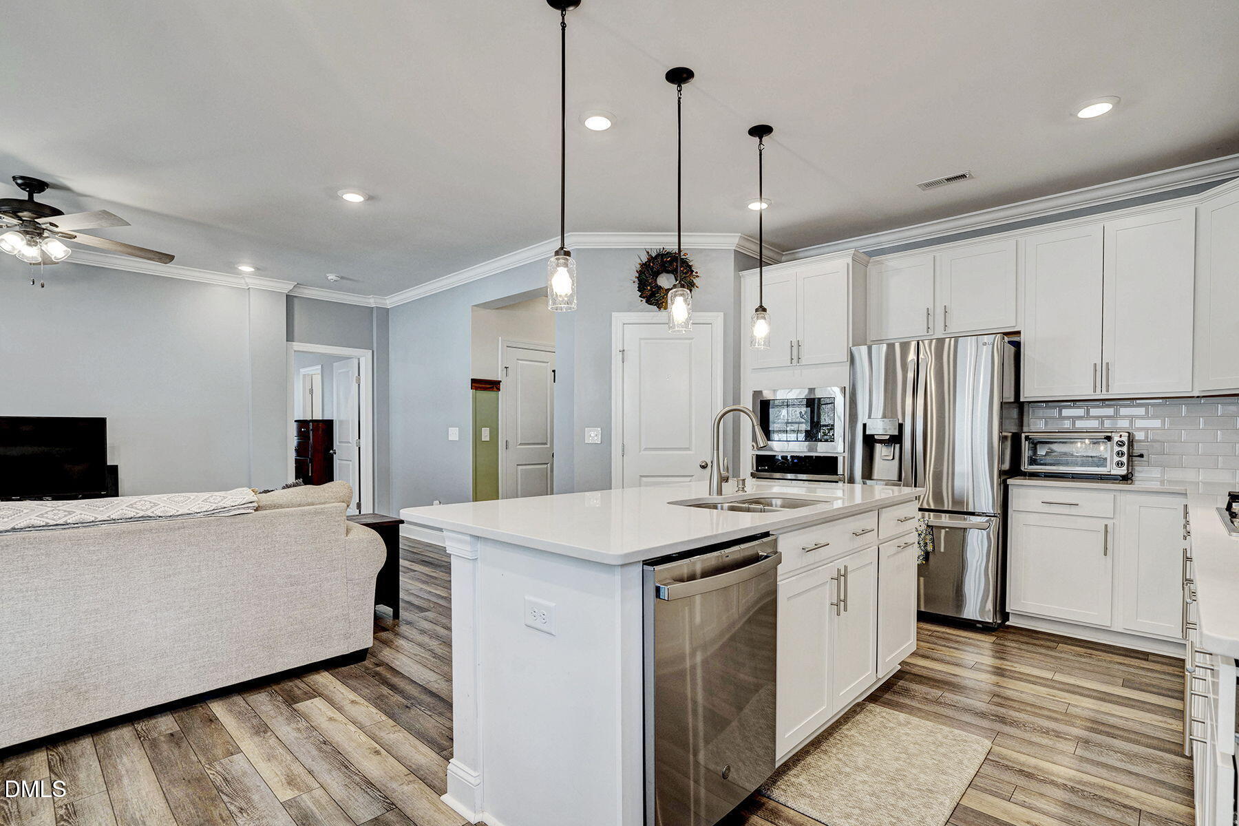 244 Chateau Way Angier, NC 27501 - Photo 16 of 30 a kitchen with stainless steel appliances kitchen island granite countertop a sink a stove and refrigerator