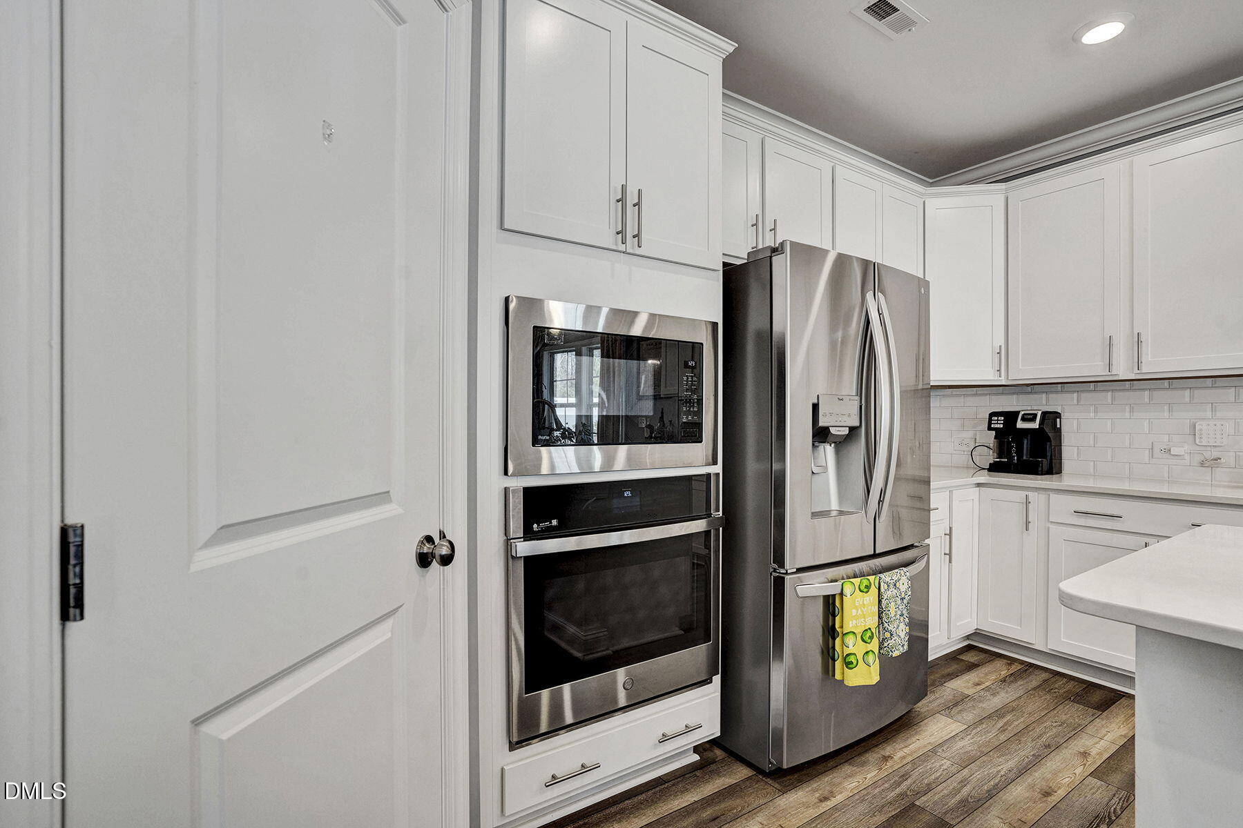 244 Chateau Way Angier, NC 27501 - Photo 18 of 30 a kitchen with a refrigerator and white cabinets