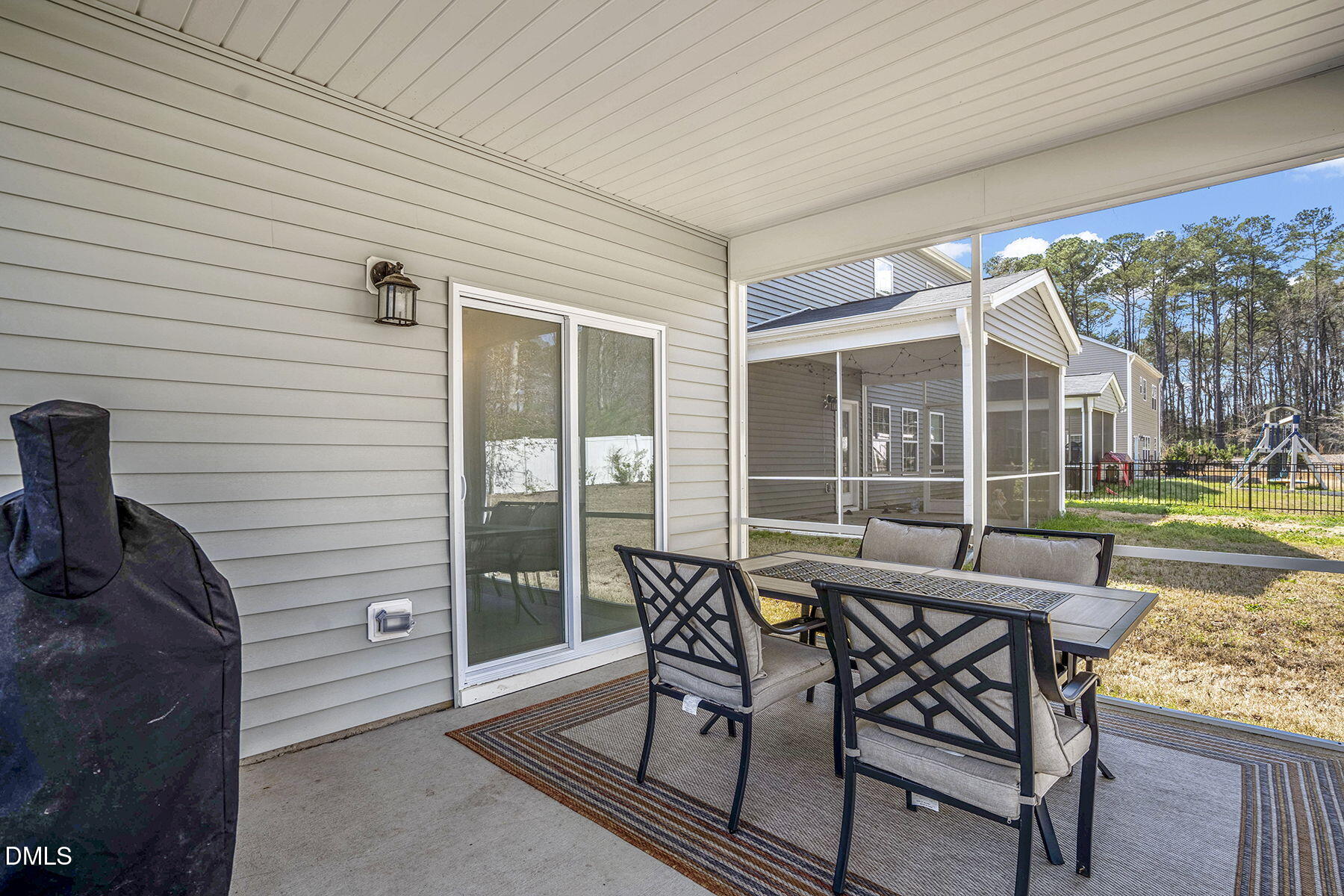 244 Chateau Way Angier, NC 27501 - Photo 26 of 30 a view of a patio with a dining table and chairs