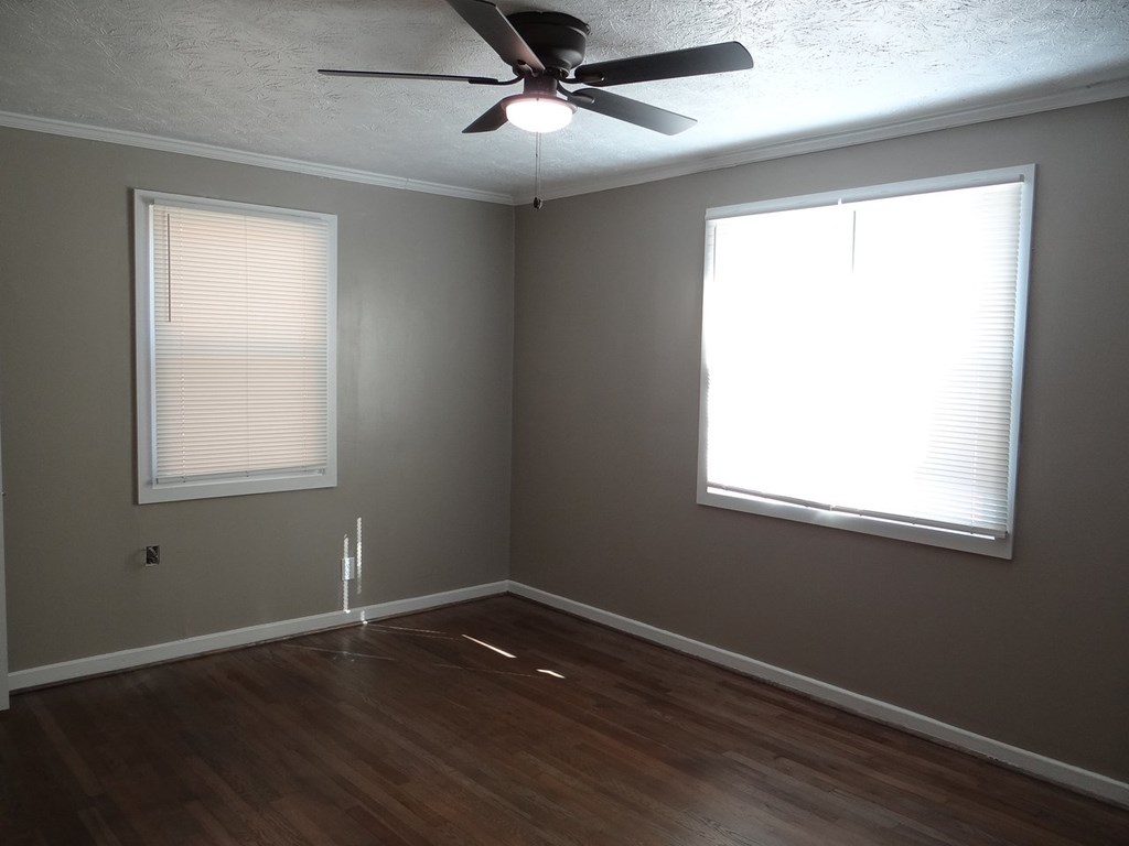 345 29th Avenue Columbus, GA 31903 - Photo 15 of 18 a view of an empty room with wooden floor and a window
