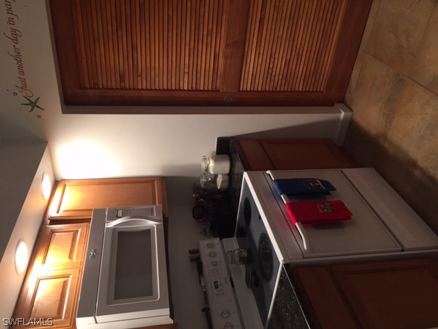 8071 Country Road, Unit 104 Fort Myers, FL 33919 - Photo 8 of 18 a kitchen with a stove and a microwave