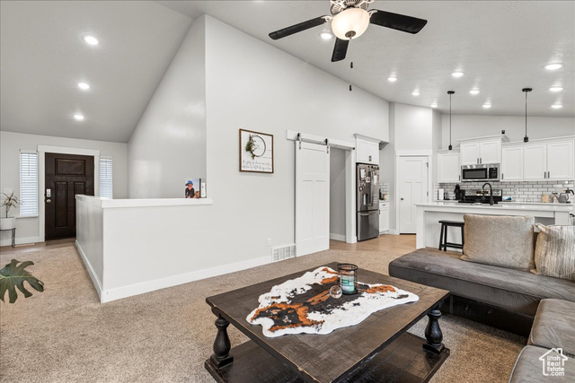 464 South Trejo Rdg Road Grantsville, UT 84029 - Photo 7 of 33 Living room featuring a barn door, high vaulted ceiling, ceiling fan, recessed lighting, and baseboards
