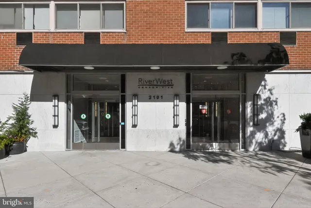 a front view of a building with traffic signal lights