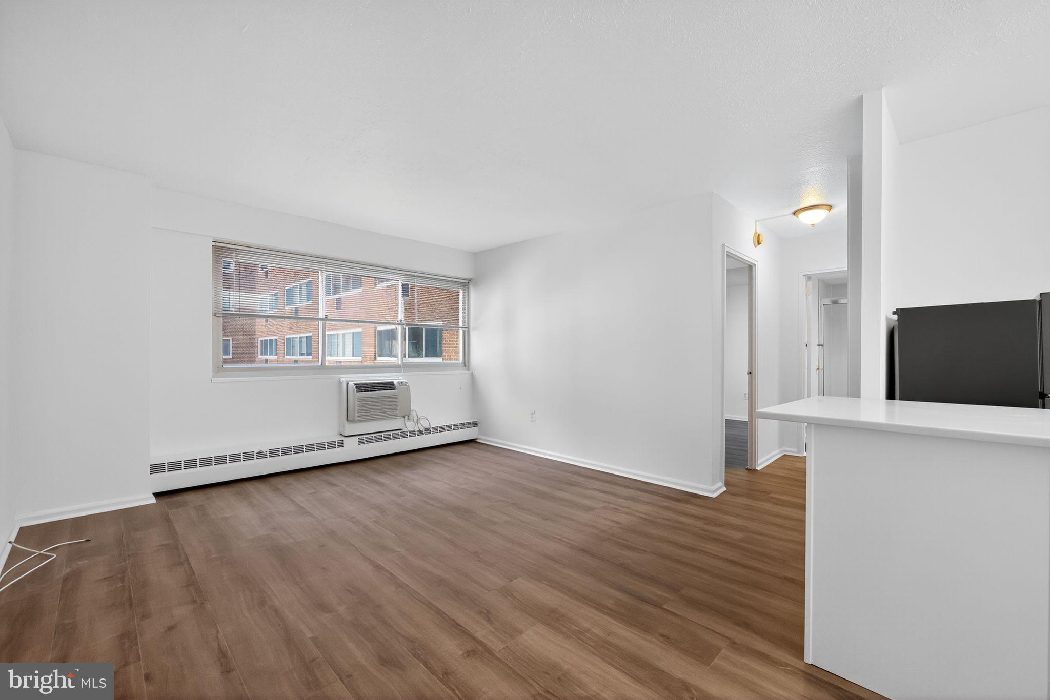 2101-17 Chestnut Street, Unit 1121 Philadelphia, PA 19103 - Photo 13 of 42 wooden floor in an empty room with a window