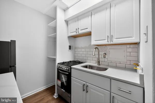 a kitchen with cabinets and a stove top oven