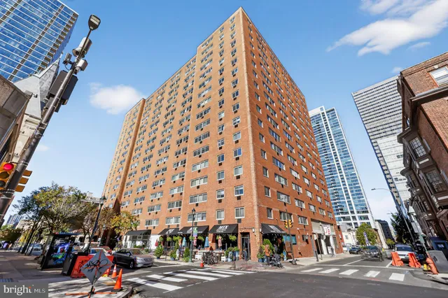 a view of a tall building next to a road