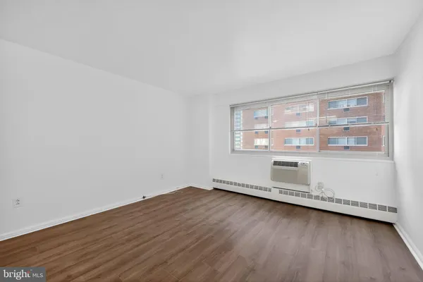 a view of a room with wooden floor and window