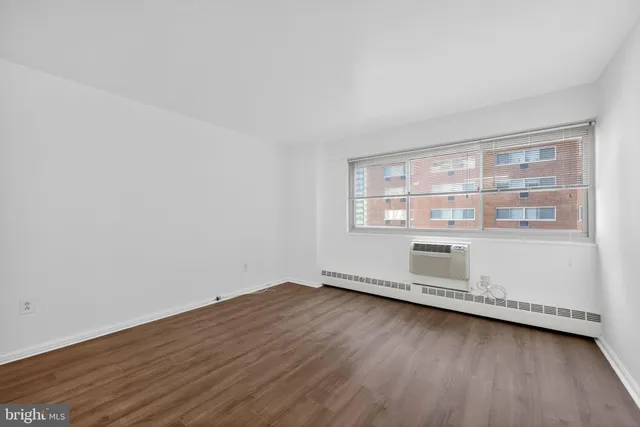 a view of a room with wooden floor and window