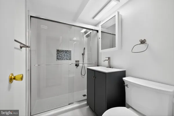 a bathroom with a sink toilet and shower