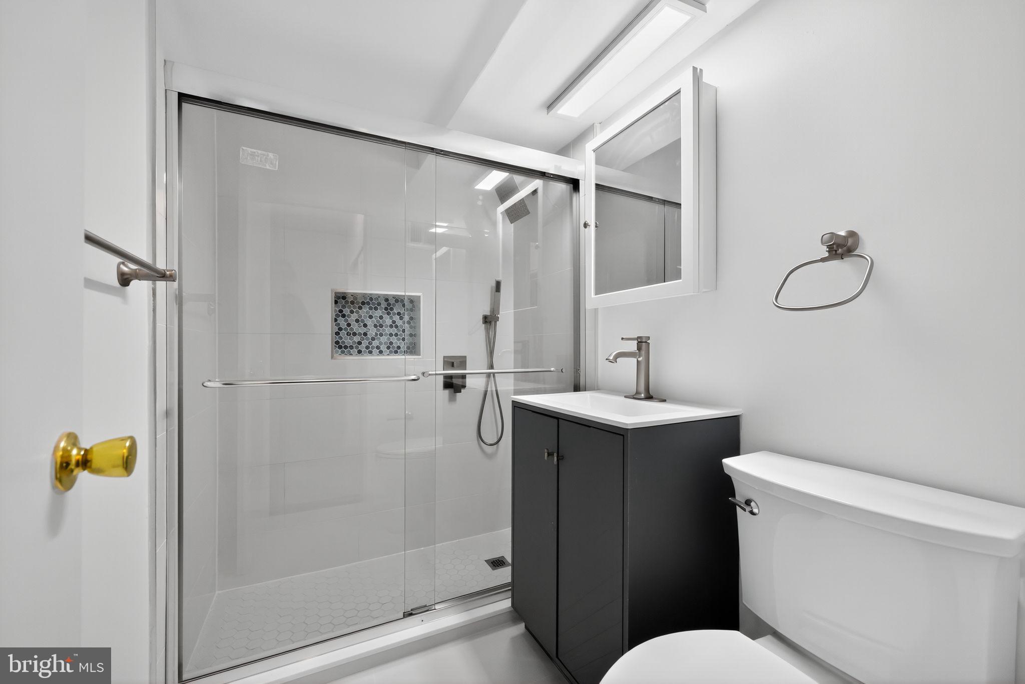 2101-17 Chestnut Street, Unit 1121 Philadelphia, PA 19103 - Photo 30 of 42 a bathroom with a sink toilet and shower