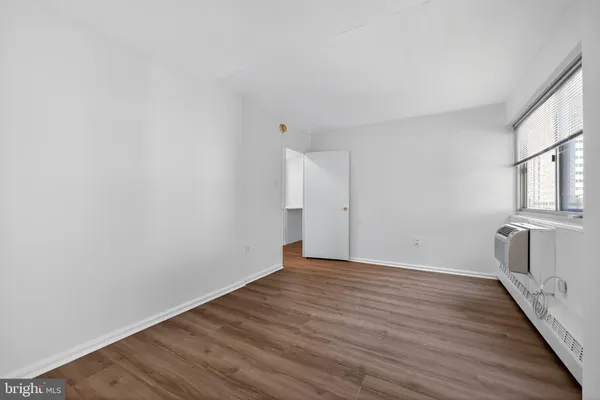 a view of a room with wooden floor and brick walls