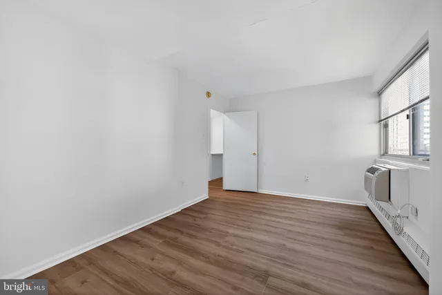a view of a room with wooden floor and brick walls