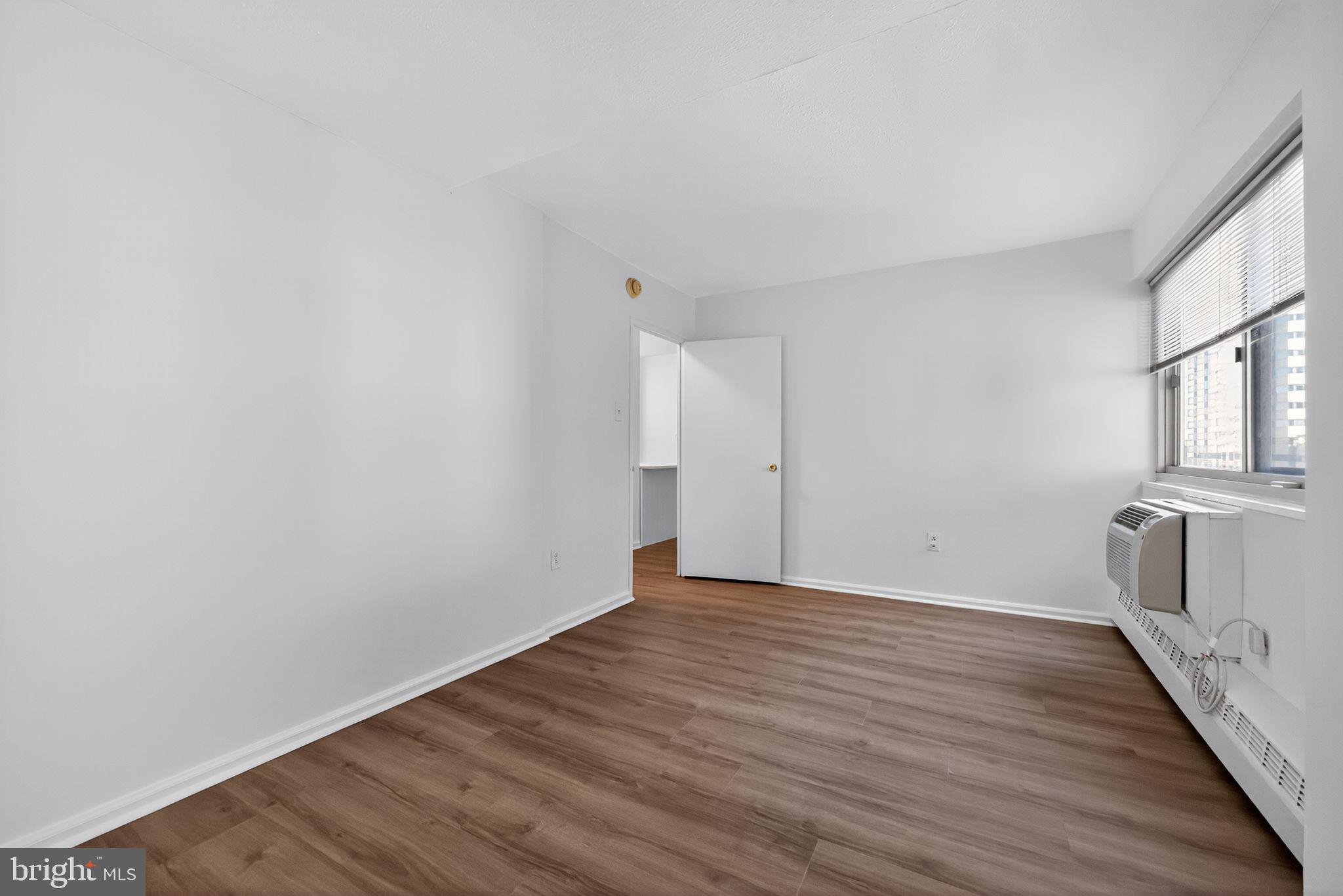2101-17 Chestnut Street, Unit 1121 Philadelphia, PA 19103 - Photo 33 of 42 a view of a room with wooden floor and brick walls