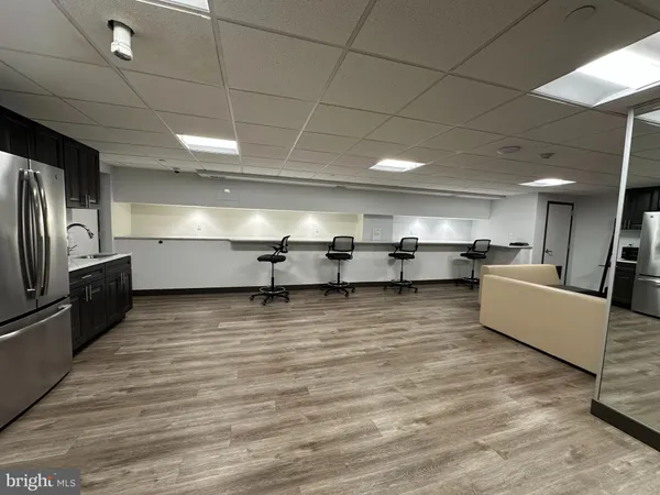 a living room with lots of furniture and kitchen view