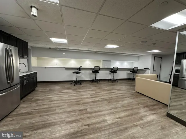 a living room with lots of furniture and kitchen view