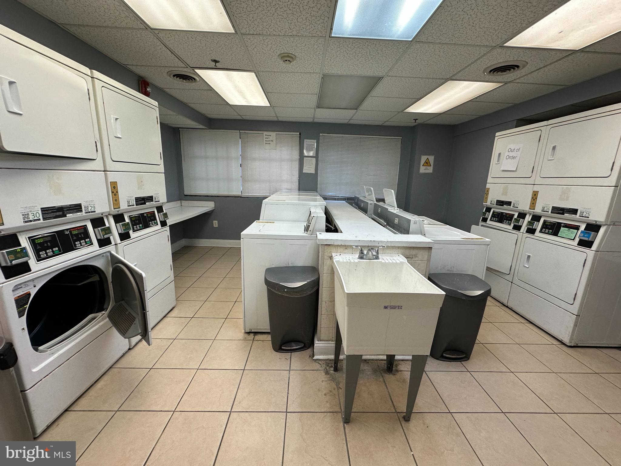 2101-17 Chestnut Street, Unit 1121 Philadelphia, PA 19103 - Photo 40 of 42 a utility room with dryer washer and a view of living room