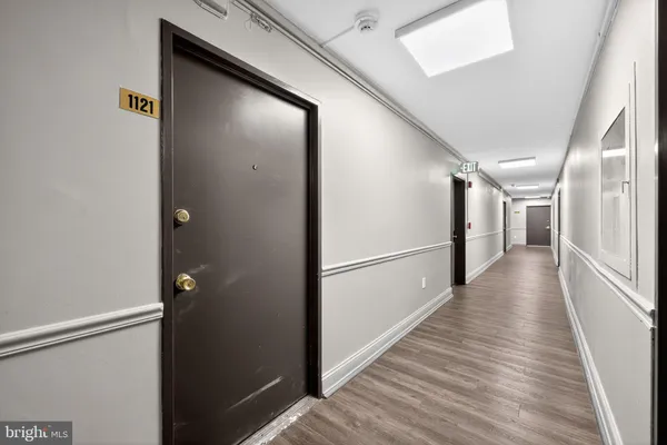 a view of a hallway with wooden floor