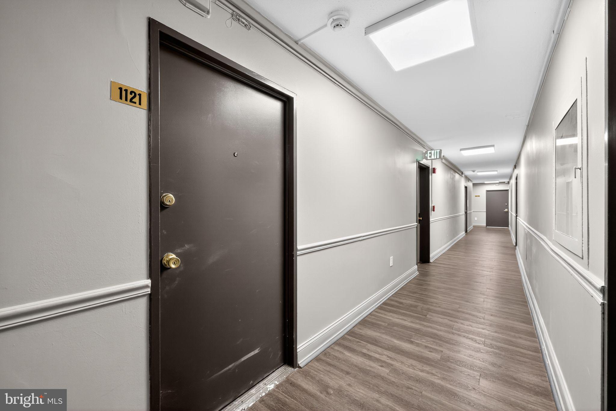 2101-17 Chestnut Street, Unit 1121 Philadelphia, PA 19103 - Photo 5 of 42 a view of a hallway with wooden floor