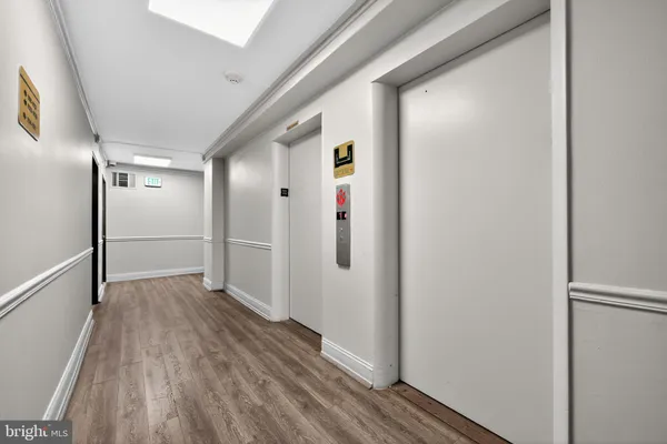 a view of hallway with wooden floor