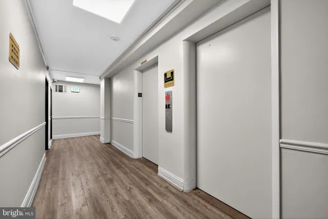 a view of hallway with wooden floor