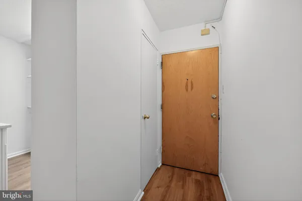 a view of a hallway with wooden floor