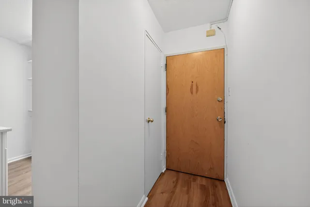a view of a hallway with wooden floor