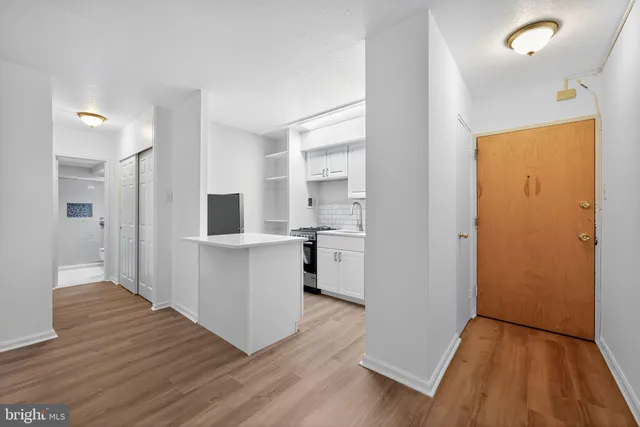 a view of kitchen with wooden floor and electronic appliances