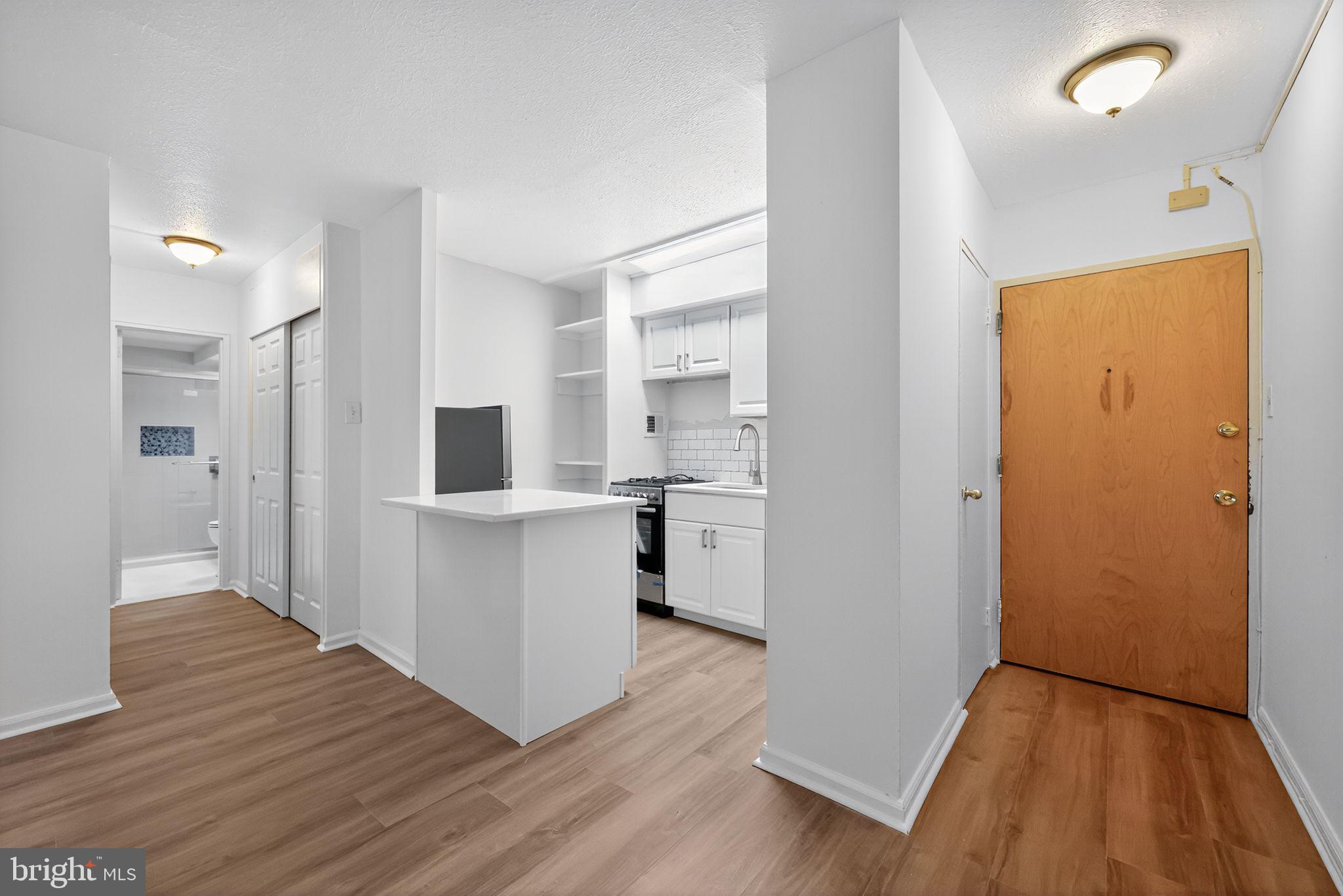 2101-17 Chestnut Street, Unit 1121 Philadelphia, PA 19103 - Photo 9 of 42 a view of kitchen with wooden floor and electronic appliances