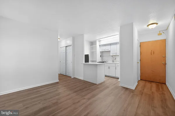 a view of a kitchen with wooden floor and a sink