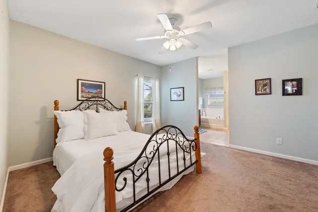 a spacious bedroom with a bed and a chandelier