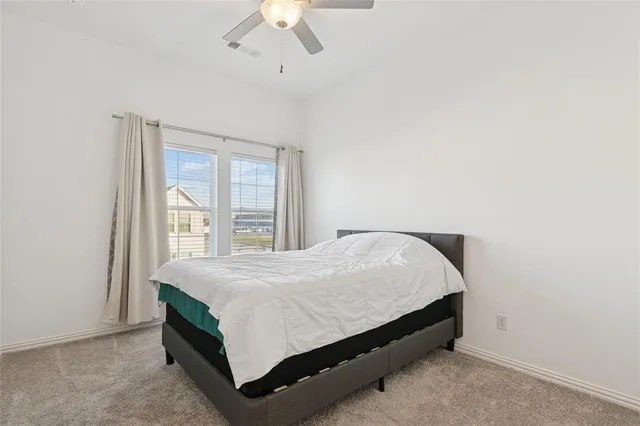 a bed sitting in a bedroom next to a window