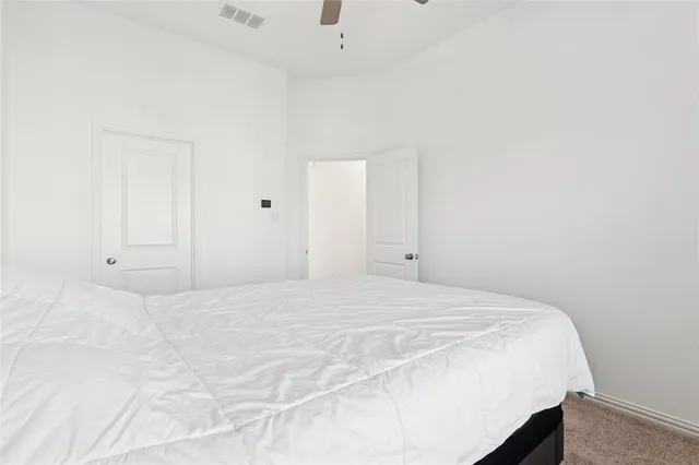 a bedroom with a bed and a cabinets