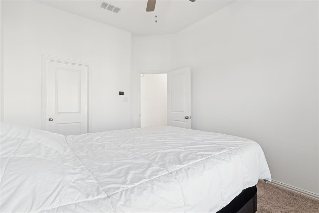 4703 Kindred Street Haltom City, TX 76117 - Photo 19 of 23 a bedroom with a bed and a cabinets