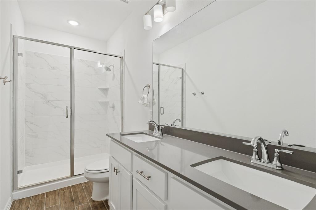 4703 Kindred Street Haltom City, TX 76117 - Photo 20 of 23 a bathroom with a sink a toilet and shower