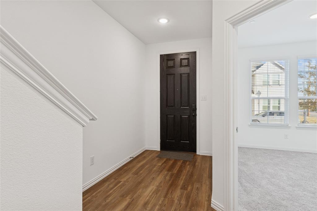 4703 Kindred Street Haltom City, TX 76117 - Photo 2 of 23 wooden floor in an empty room