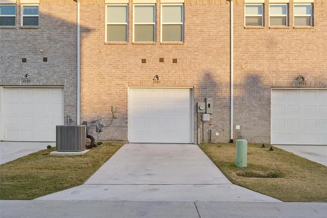 a view of a brick house with a yard
